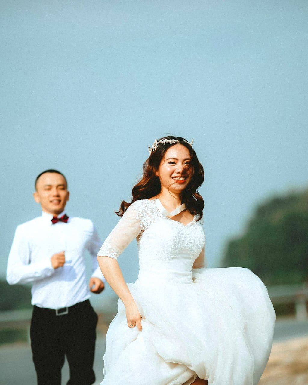 married couple running down costa rica wedding venue