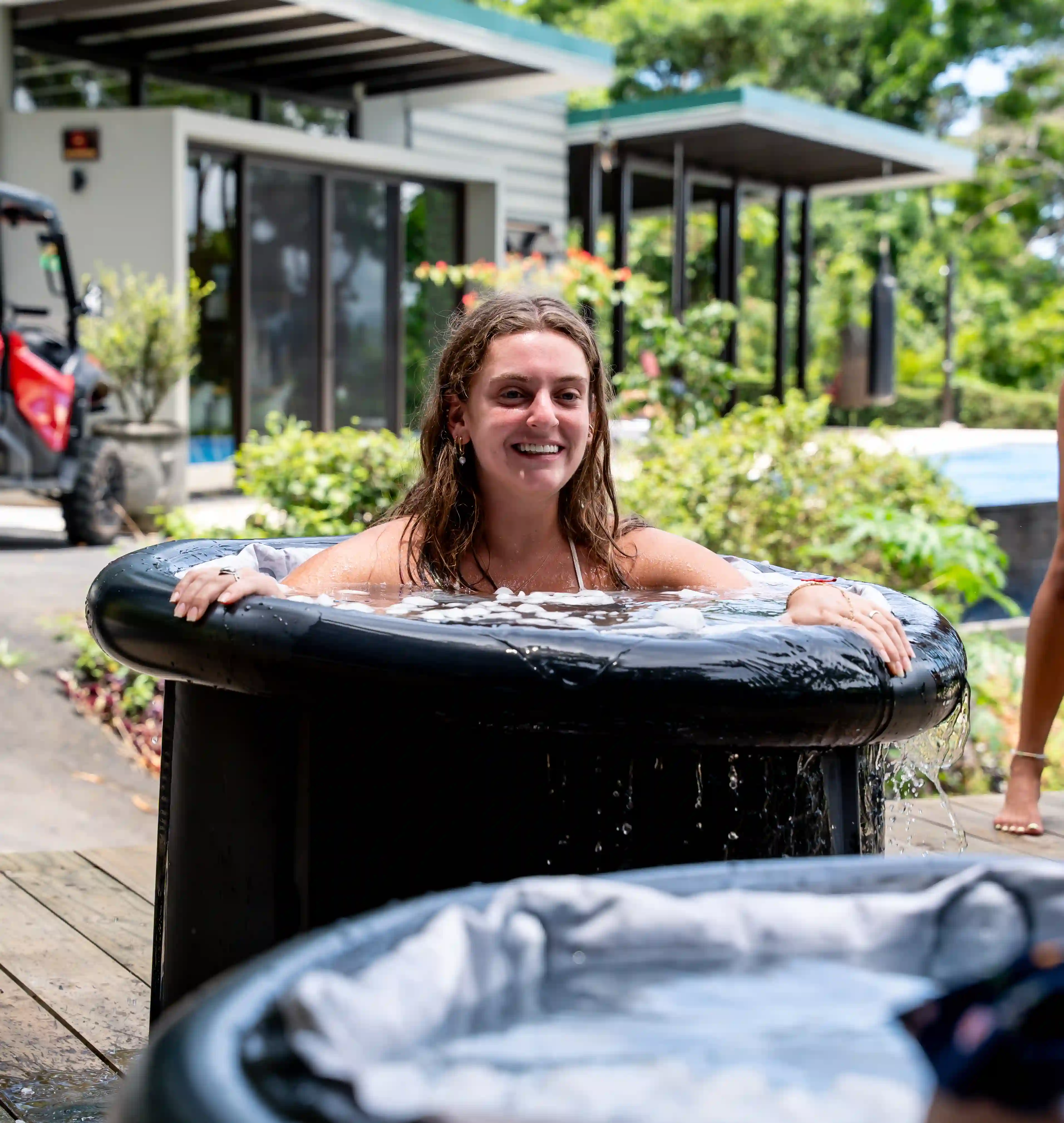 Guest enjoying the cold plunge tub filled with icy water