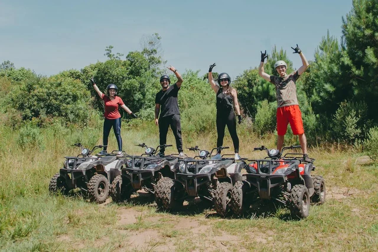 Adventurous ATV excursion with a group posing on their vehicles near Vajra Jahra Retreat Center, offering fun experiences for Family Reunion Vacation Rentals.