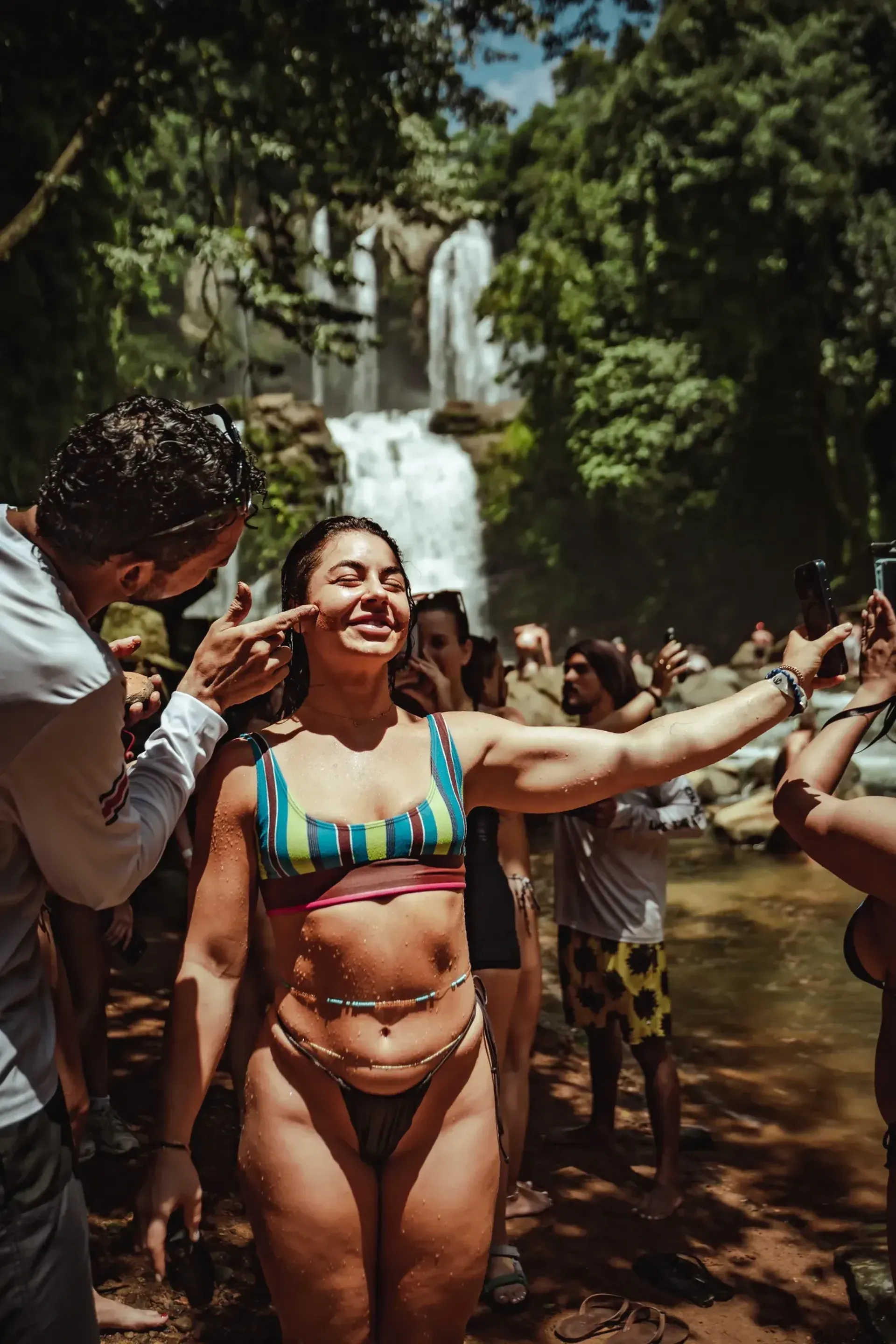 girl at nauyaca waterfall with mud facial