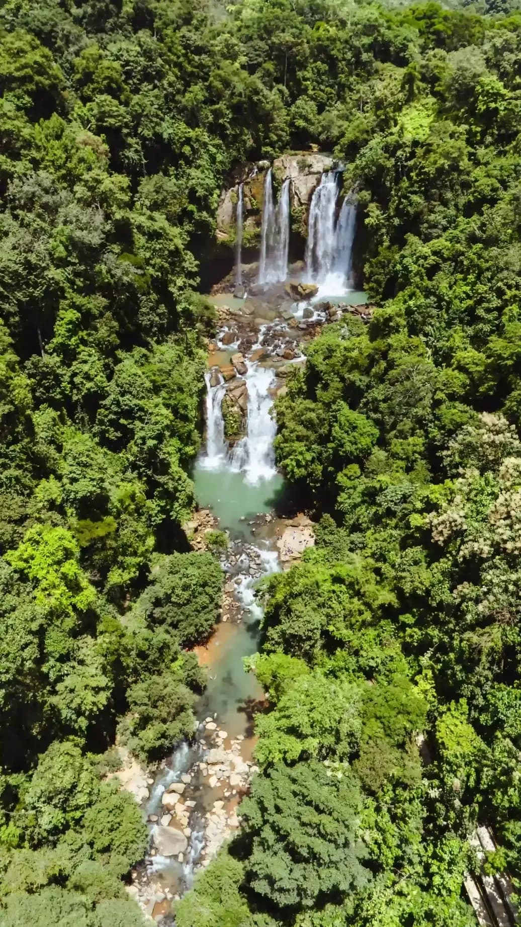 Aerial view of the Diamante Waterfalls surrounded by lush jungle near Vajra Jahra Retreat Center, a Costa Rica retreat center.