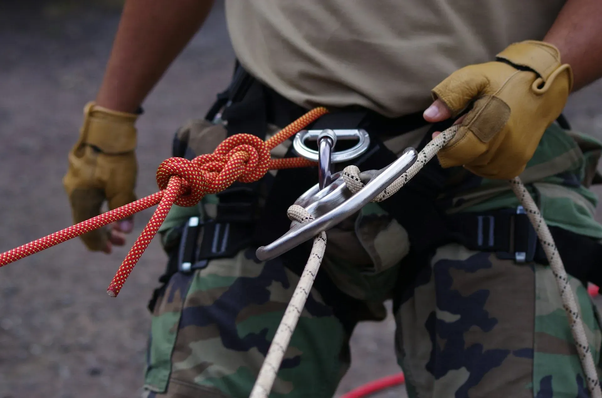 Close-up of a guide preparing climbing ropes and harness gear for an outdoor adventure near Vajra Jahra Retreat Center in Costa Rica.