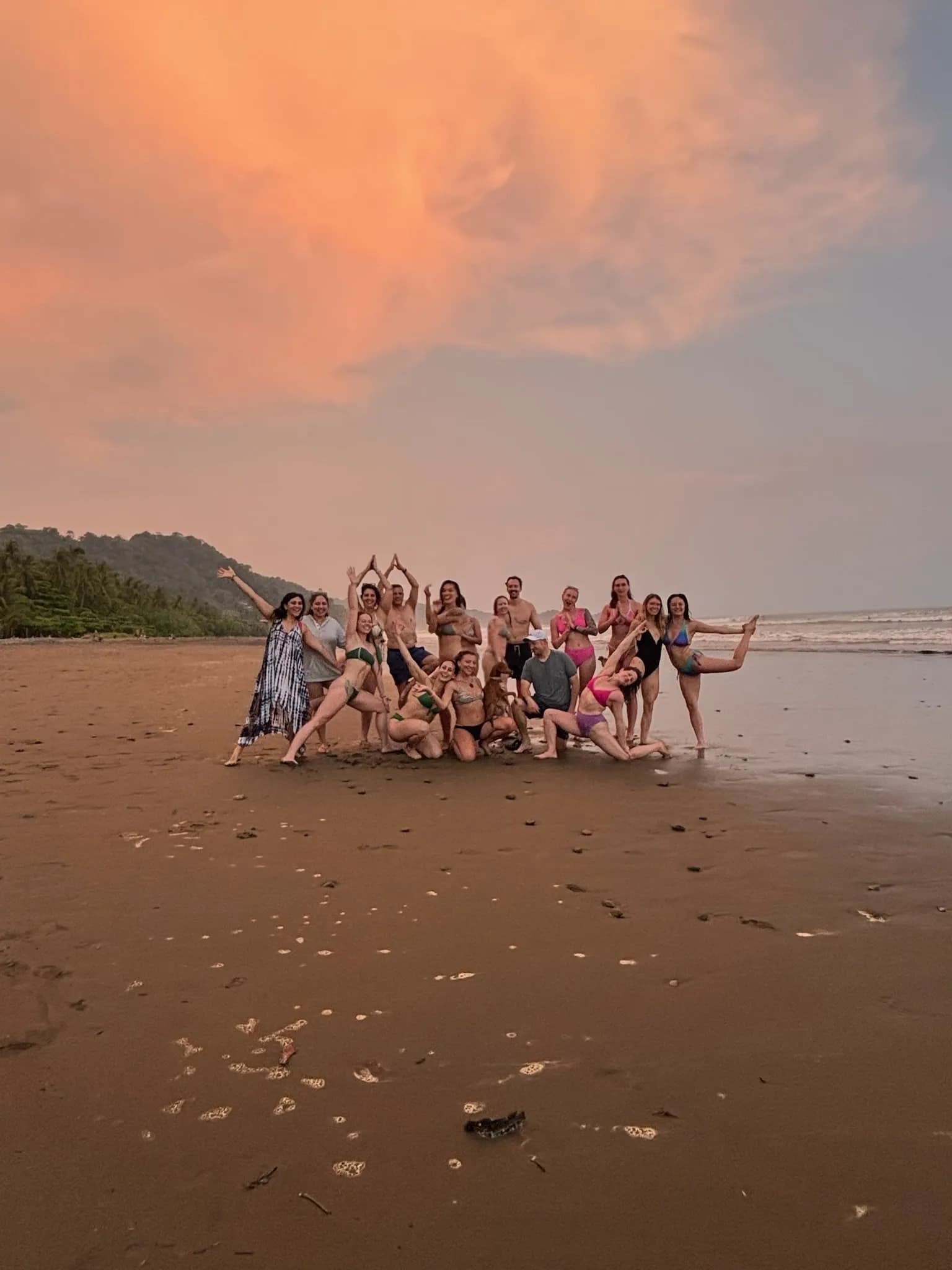 Group enjoying a playful sunset moment on the beach near Vajra Jahra Retreat Center, a memorable experience for family reunion vacation rentals.