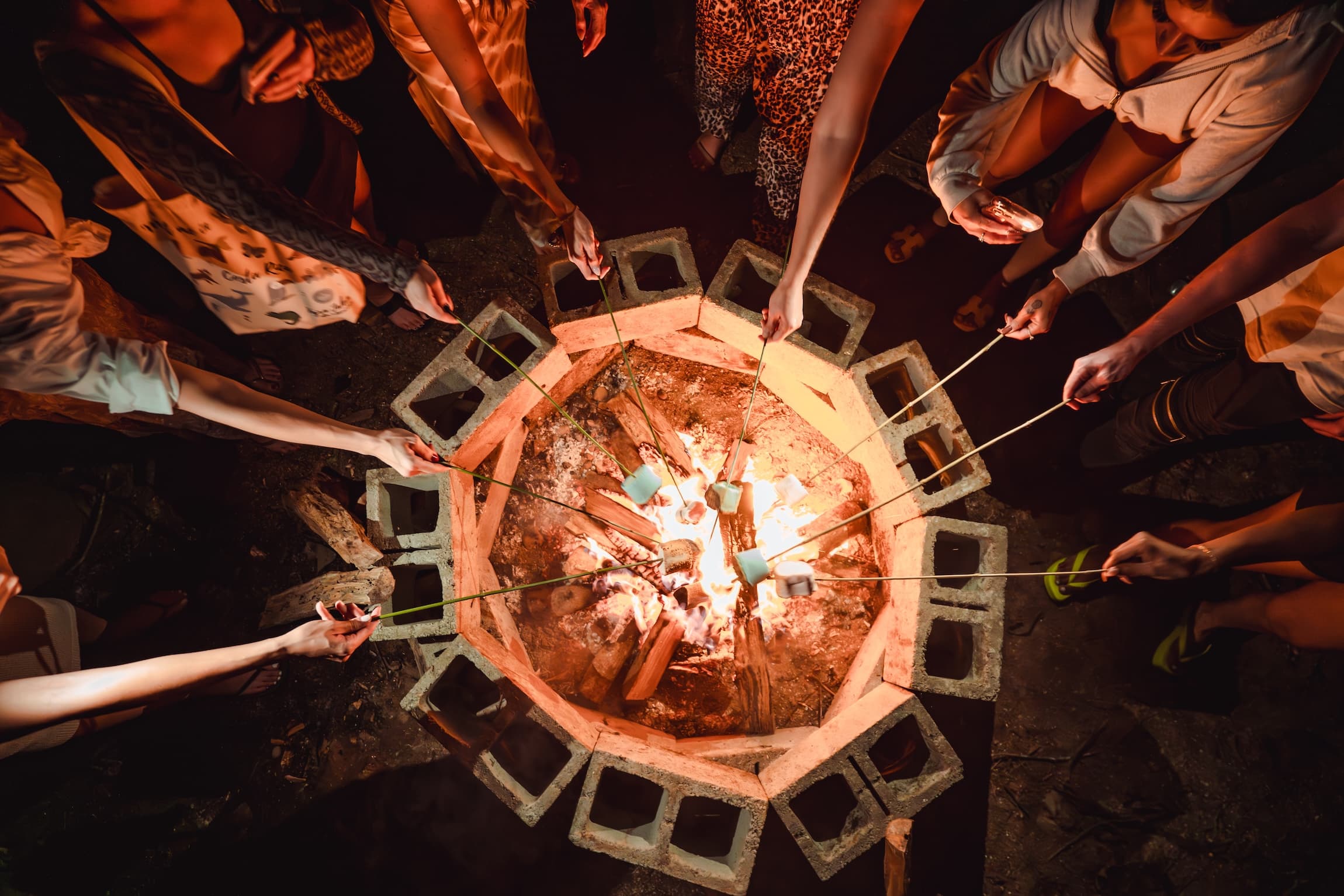 Team members gathered around a fire pit at Vajra Jahra to celebrate a successful team building retreat.