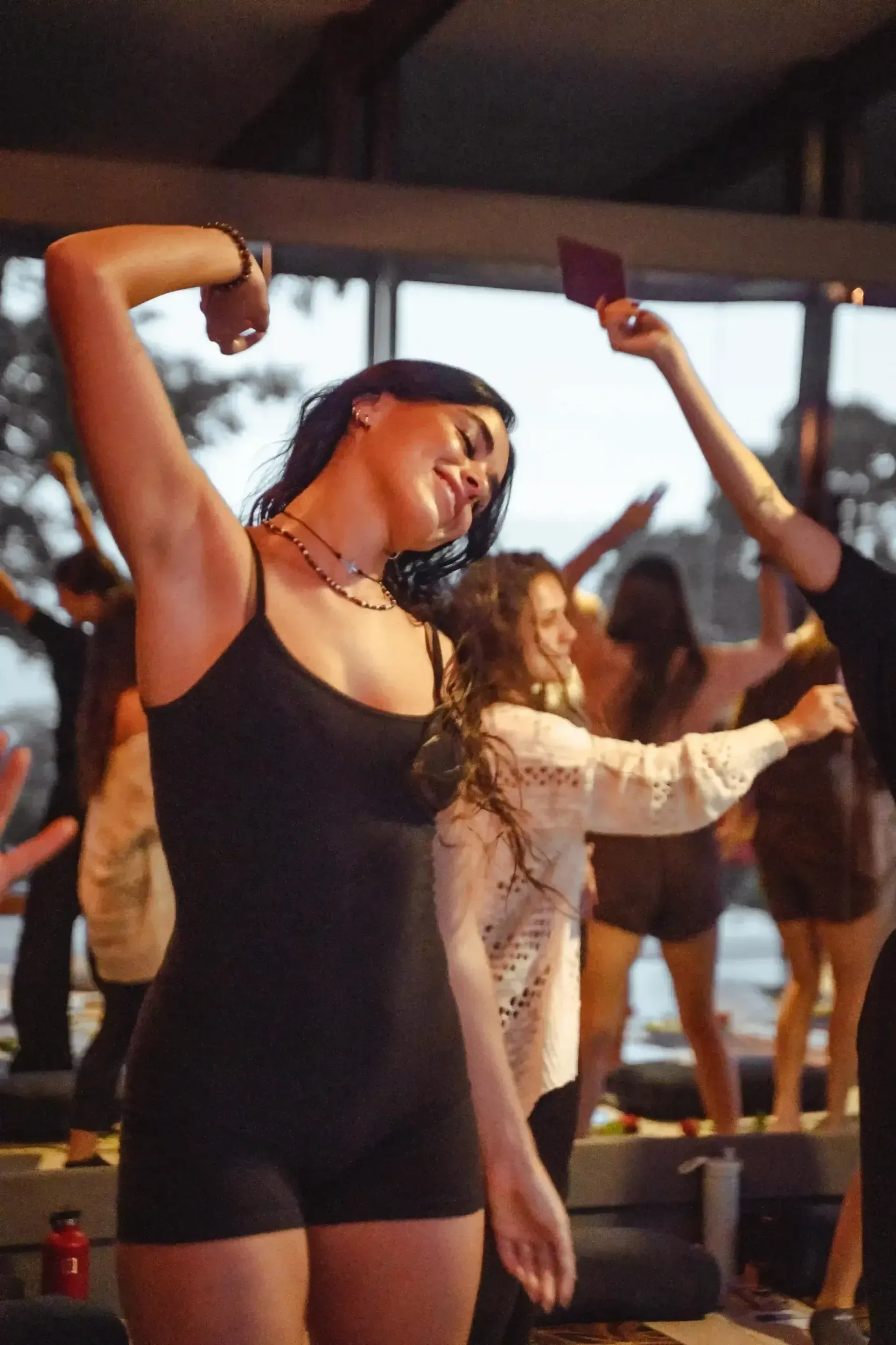 Dancing during a joyful group movement practice at Vajra Jahra Retreat Center, an immersive Costa Rica retreat center.