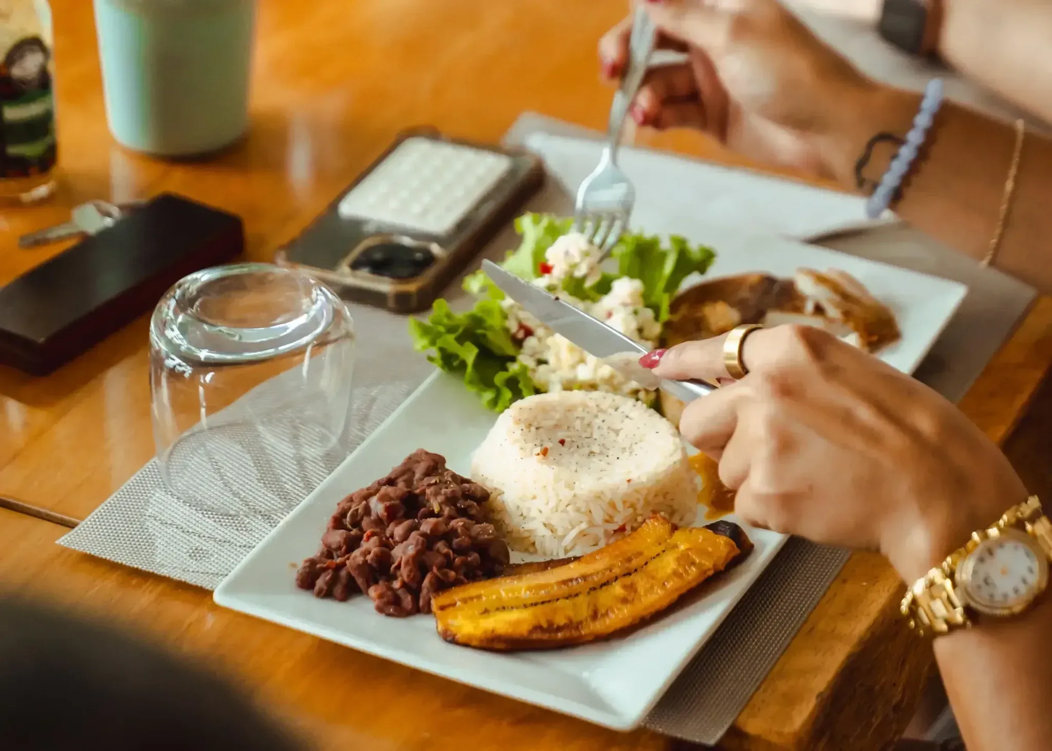 Guest enjoying a traditional plate of rice, beans, salad, and plantains at Vajra Jahra Retreat Center, an authentic Costa Rica retreat center known for flavorful meals.