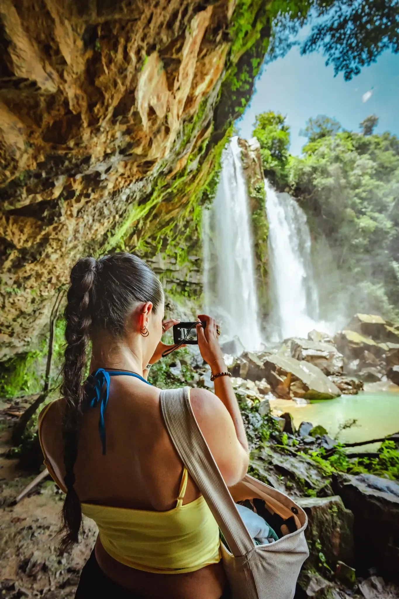 Guest photographing the Nauyaca waterfall near Vajra Jahra Retreat Center, part of nature-inspired Airbnb vacation packages in Costa Rica.