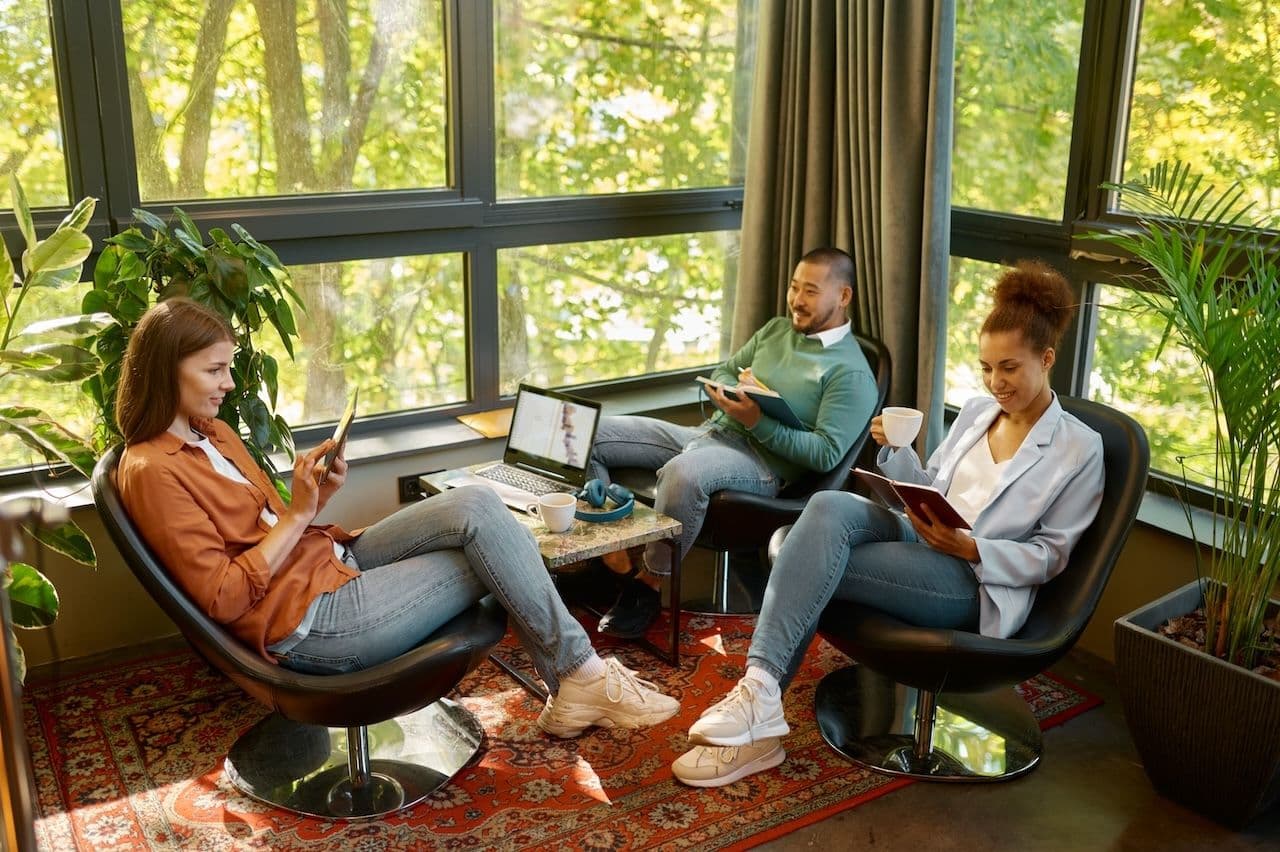 3 people reading and lounging on a luxury corporate retreat