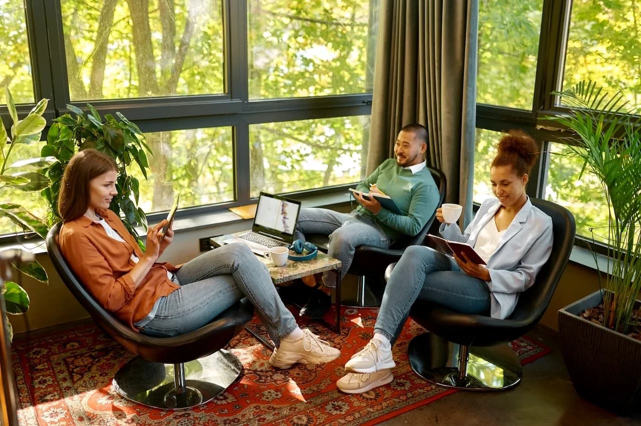 3 people reading and lounging on a luxury corporate retreat