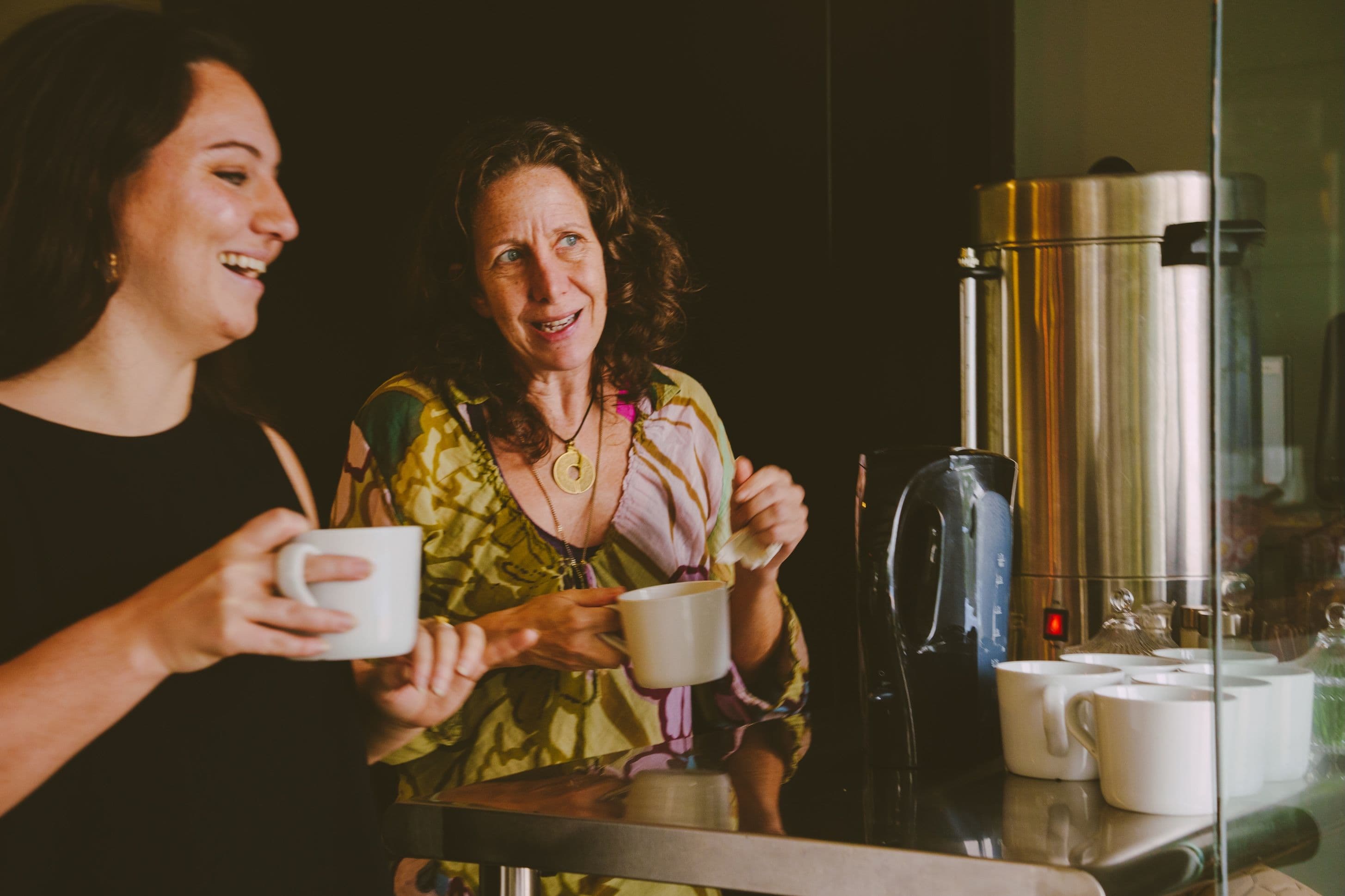 Two women sharing conversation over coffee on a writing retreat in Costa Rica.
