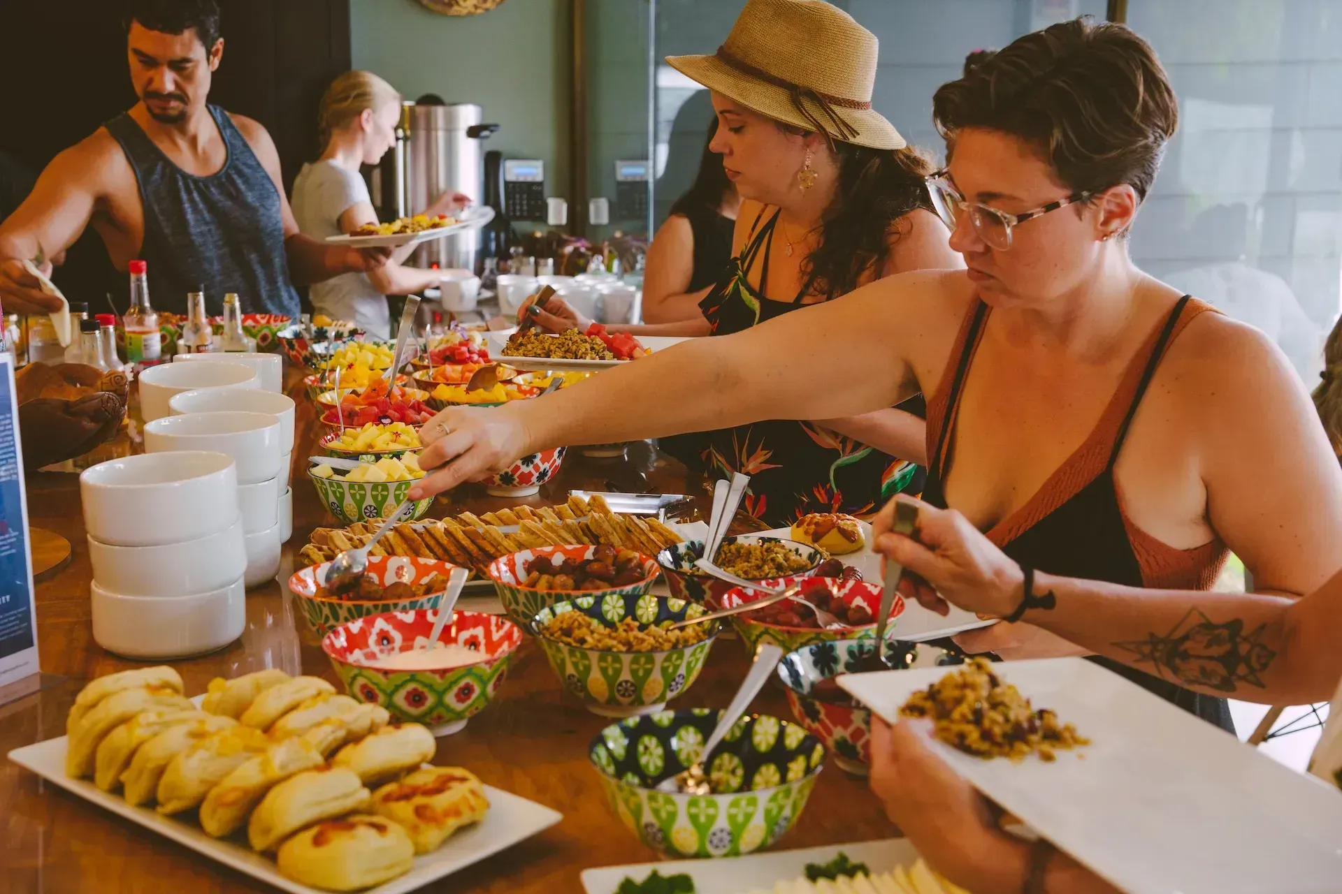 Guests enjoying a vibrant buffet of fresh, colorful dishes at Vajra Jahra Retreat Center, a Costa Rica retreat center.