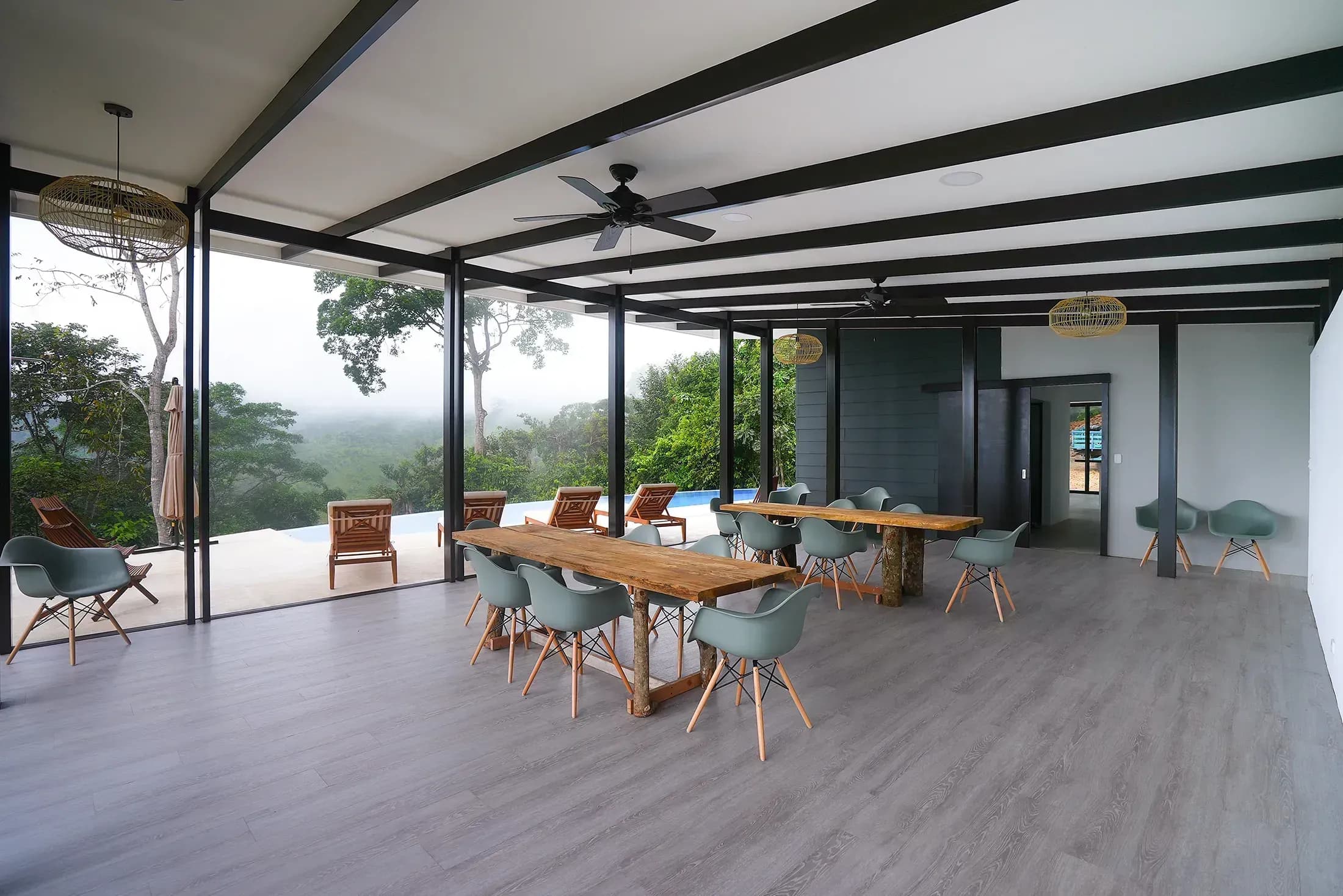 Spacious communal seating area overlooking the jungle at Vajra Jahra Retreat Center, perfect for meals and activities during Family Reunion Vacation Rentals.