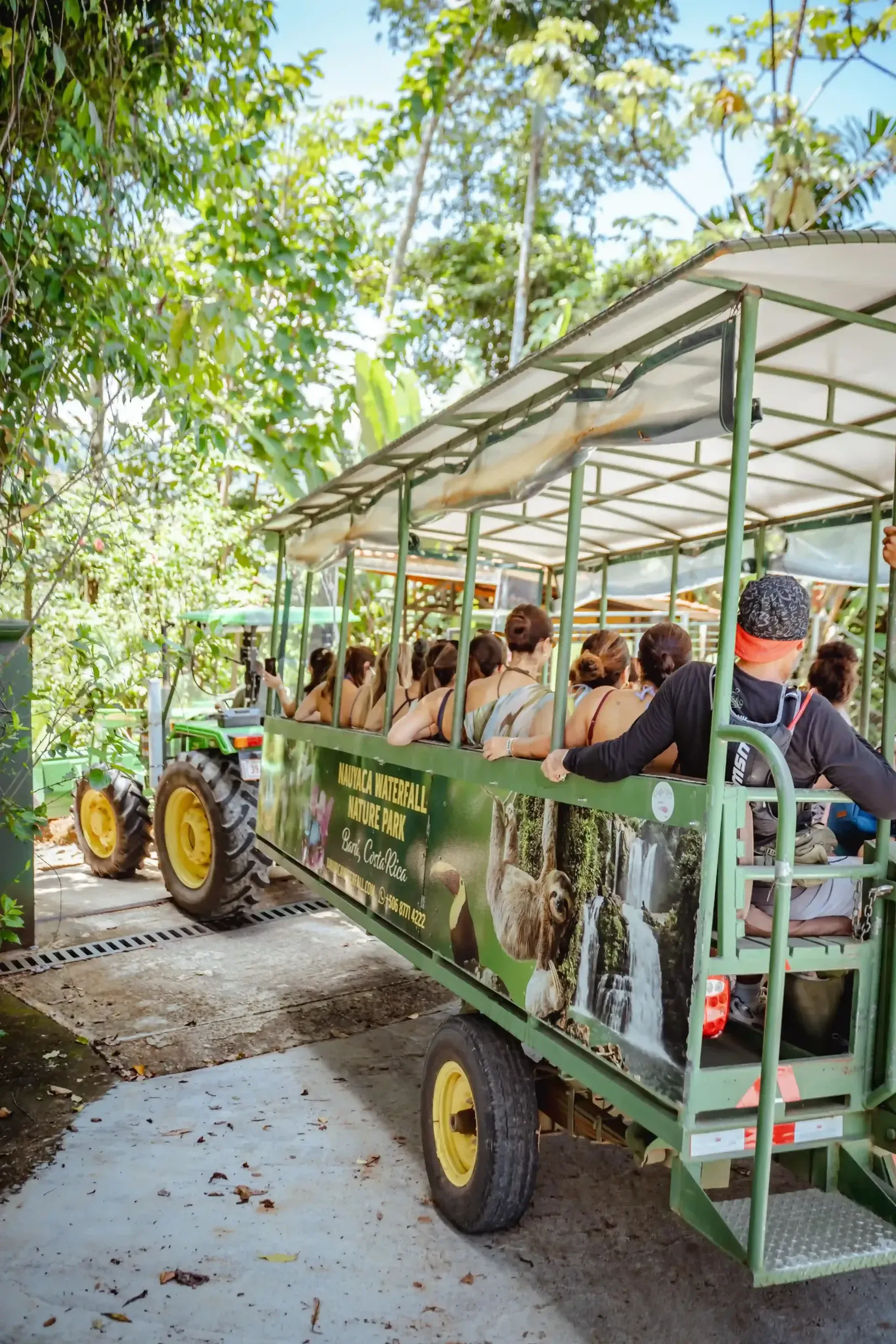 Group of guests on an open-air tractor ride through the jungle near San Jose, Costa Rica.