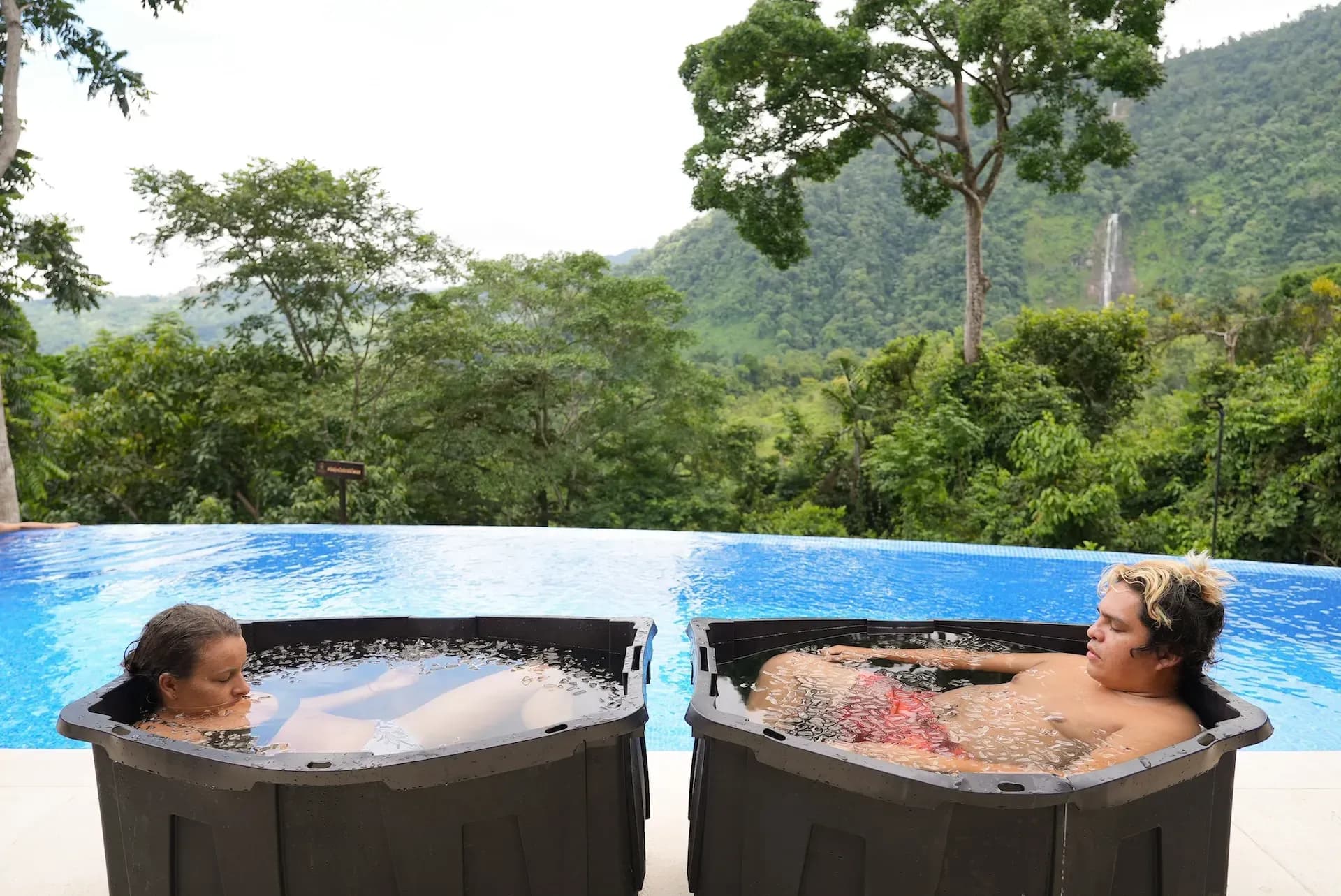 Guests relaxing in cold plunge baths at Vajra Jahra, a nature-immersed wellness retreat center.