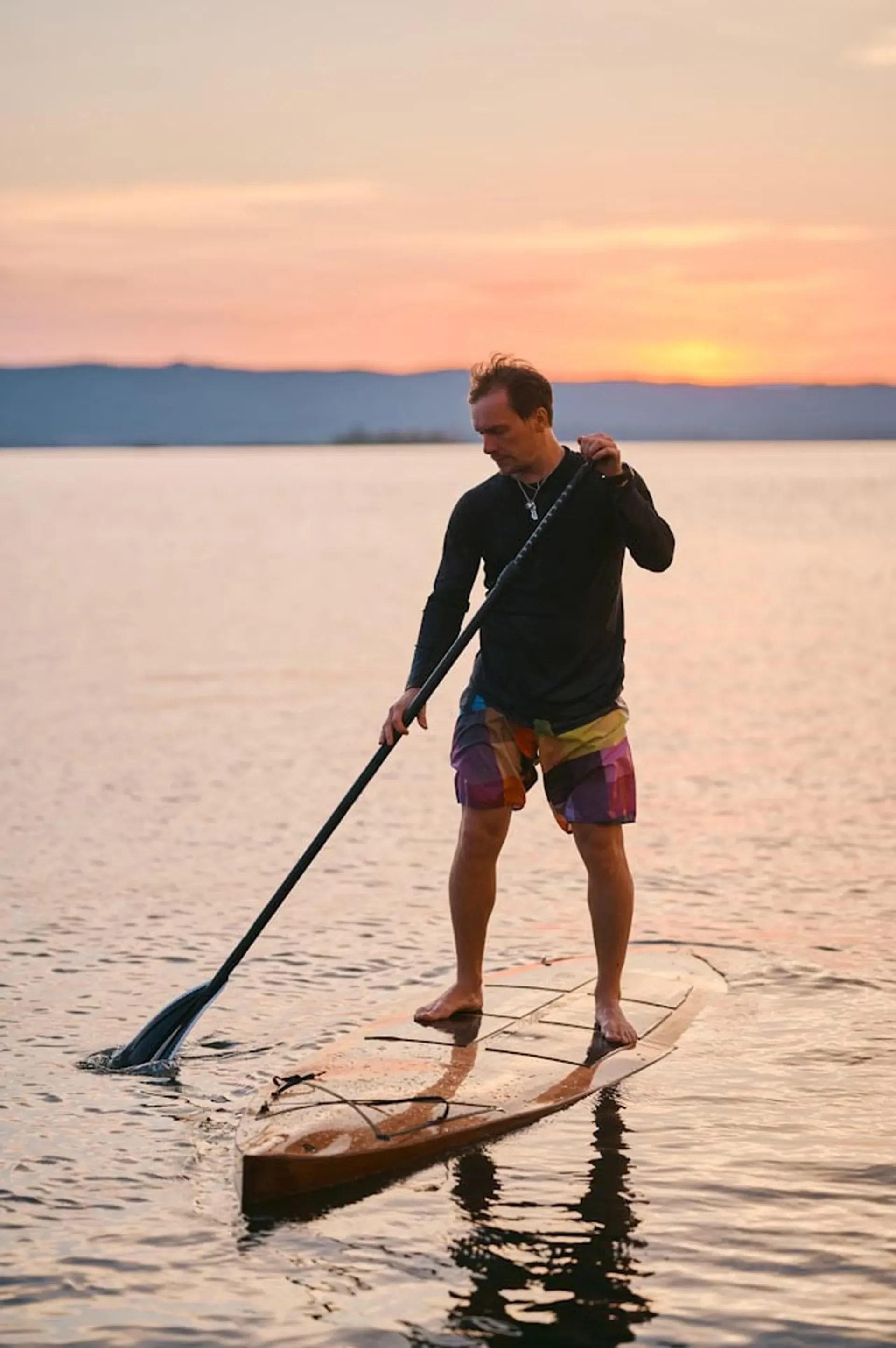 Peaceful paddleboard experience at sunset as part of the outdoor activities at Vajra Jahra Wellness Retreat Center.
