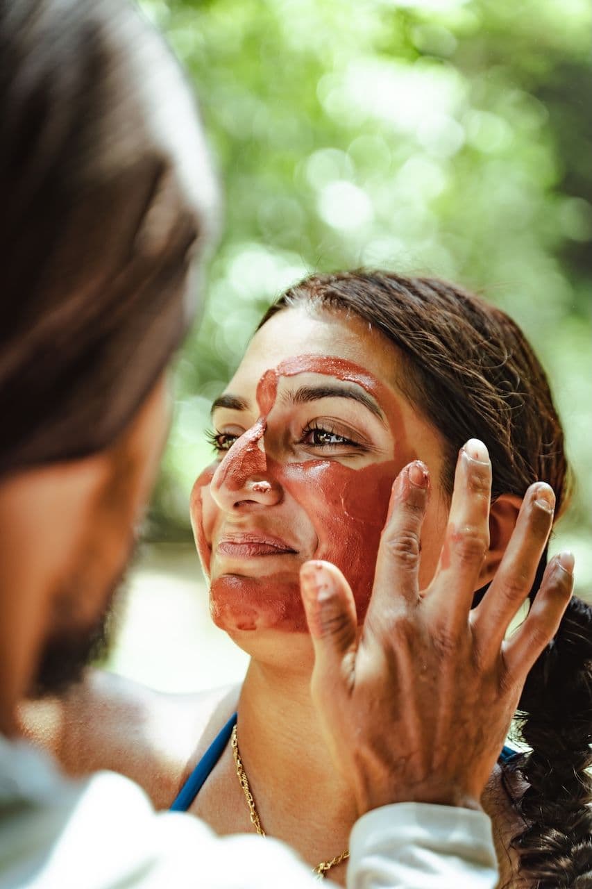 wellness retreat guest receiving mud facial